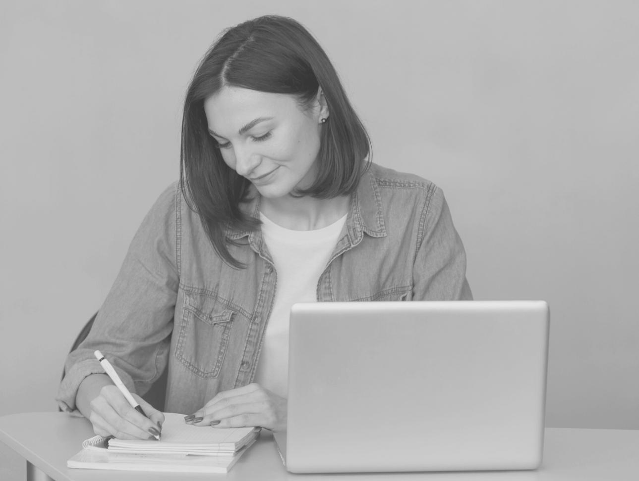 Person reviewing monthly budget spreadsheet with calculator and financial documents